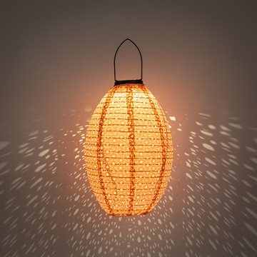 Dekorativ oval solcellelampe i i perforeret stof, i lyserød farve CB739183